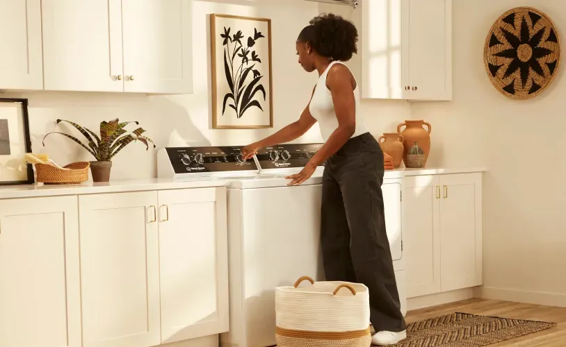 woman-adjusting-settings-on-speedueen-washing-machine